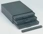 Preview: The image shows several black drawers stacked on top of each other. There are a total of four drawers, three of which are open. Next to the drawers, there is a small black bar.