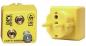 Preview: The image shows a yellow grounding plug from DPV Electronics. It has two holes and a round socket on the right side, which is used for electrical devices.
