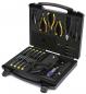Preview: The image shows a toolbox with an open lid. Inside, various tools such as screwdrivers, pliers, and a cable are arranged in a padded, structured compartment.