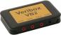 Preview: The image shows a compact, rectangular device in black with a yellow top layer that reads "Veribox VB2". It has three red and one black connector on the front.