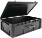 Preview: The suitcase is large, rectangular, and made of black plastic. It has a lid that is open upwards, and side handles for carrying. The inside is empty and spacious.