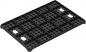 Preview: The image shows a black plastic plate with many small holes and rectangular protrusions. The plate is rectangular and has a textured design for stabilization.