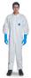 Preview: A person is wearing a white protective suit with long sleeves, blue latex gloves, and safety goggles. The background is neutral and dimmed.