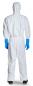 Preview: The image shows a person from behind, dressed in a white protective suit with a hood. The hands are in blue rubber gloves. The shoes are black and sturdy.