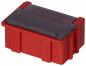 Preview: The image shows a small, rectangular box in bright red with a transparent lid. It has raised areas on the sides that facilitate gripping.