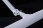 Preview: The image shows a modern, white desk lamp arm that is adjustable. The lamp has a simple, rectangular base and a light switch in the middle. The background is black.