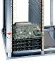 Preview: The image displays a vertical computer rack with multiple green-painted circuit boards. The boards are stacked in a metal casing, equipped with several connectors and slots.