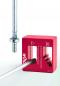 Preview: The image shows a red tool with multiple notches for guidance. Next to it is a metal screw with a narrow end that fits into the notches.