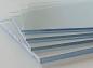 Preview: In the picture, several glass panes are stacked on top of each other. They are clear and reflect light, giving them a glassy, cool appearance. The edges are sharp.