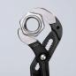 Preview: The image shows an adjustable wrench gripping a metal nut. The wrench has black handles and a shiny, silver working surface with sharp edges.