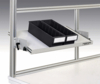 Preview: The image shows a warehouse-like shelving system with a pull-out shelf. On it are two black plastic containers with space for compartments, attached to a sturdy, silver frame.