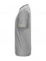 Preview: The image shows a gray T-shirt with a subtle striped pattern. It has a round neckline, short sleeves, and a yellow patch on the left side. The fit appears to be casual.