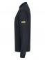 Preview: The image shows a black long-sleeve shirt made from a lightweight, textured fabric. It features a stand-up collar and a simple, elegant shape. There is a yellow logo on one sleeve.
