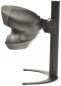 Preview: The image displays a black device with a round, dome-shaped top, mounted on a stable base. It features a button on the front and appears compact.