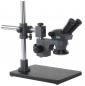 Preview: The image shows a microscope with two eyepieces. It is mounted on a sturdy, rectangular base. The stand is made of metal and has an adjustable eyepiece element.