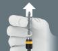 Preview: A gray background, on which a hand is holding a screwdriver with a magnetic attachment. Above the hand, an arrow points upward, indicating an action or direction.
