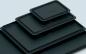 Preview: The image displays multiple black, rectangular trays in various sizes. They are stacked on top of each other, with the largest at the bottom and the smallest on top.