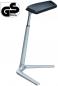 Preview: The image shows a modern, sleek table with a narrow, slightly inclined tabletop. The frame is made of silver-colored metal and has a sturdy, three-legged base.