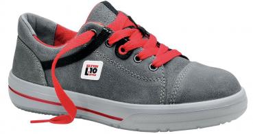 The image shows a gray suede shoe with red laces. On the side, there is a white logo. The sole is flat and white with a red accent.