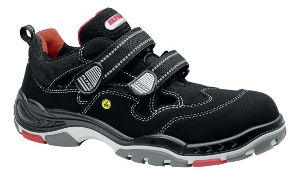 The image shows a black shoe with two wide Velcro straps. It features gray and red accents, a sturdy sole, and a sporty design, suitable for outdoor activities.