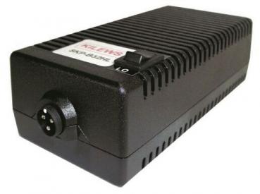 The image displays a black, rectangular device with a ribbed structure on the top. On one side, there is a circular connector and a small switch. It has a slight elevation in the middle.