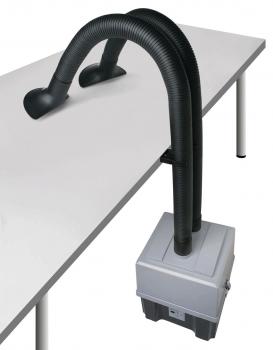 The image shows a device with two long, flexible hose arms extending from a rectangular casing on a table. The hoses are black and curved.
