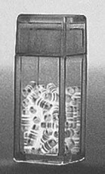 The image shows a transparent container filled with many small, spiral-shaped objects. The container is rectangular in shape and has a lid.
