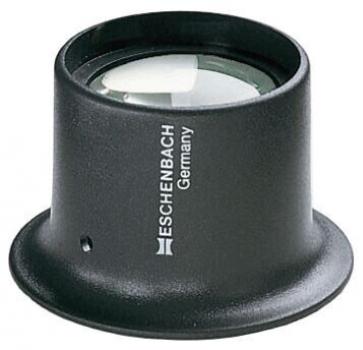 The image shows a black magnifying glass with a sturdy, round base. The lens is clear and convex, and on the base it says "ESCHENBACH Germany" in white lettering.