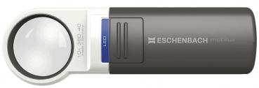 The image shows a handy reading device with a large, round glass lens and a gray, rectangular casing. On the top, there is a blue button and the inscription "ESCHENBACH".