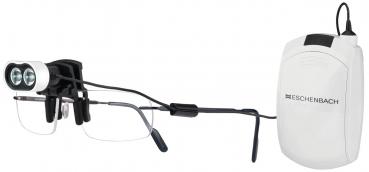 The image shows a special pair of glasses with two small cameras on the top. It is connected to a technical device that is white in color and attached to the right side.