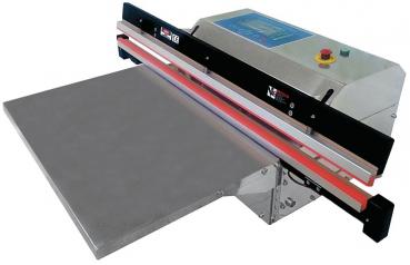Das Bild zeigt eine Siegelmaschine. Sie hat eine große, flache Arbeitsfläche und eine obere Klappe mit Bedienelementen. Die Maschine wirkt robust und ist für das Versiegeln von Materialien gedacht.