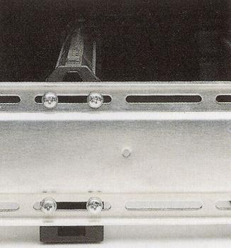 The image shows a silver metal structure with grooves and screws. This structure consists of two rails arranged parallel for fastening or guiding.