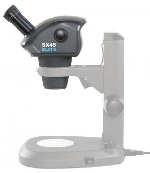 The image displays a microscope in black and gray. The upper part features a round lens and an eyepiece, while the base is flat and stable. A cable connects the microscope to a power source.
