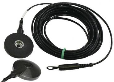 The image shows a black cable with a round end that has a small, flat, round surface. The other side has a plug. The cable is coiled and has a green marking.