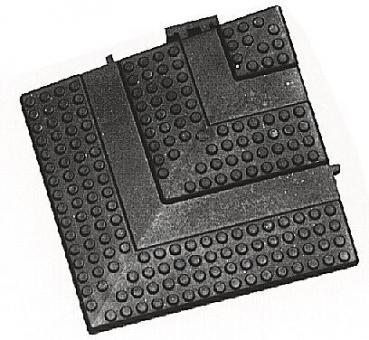 The image shows a rectangular grid pattern with raised dots and an L-shaped edge. It appears to be made of black material and is flat.