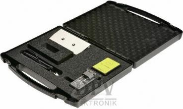 The image shows an open, black suitcase with individual compartments. Inside, there are various technical parts, including a metal plate, a small computer, and cables.