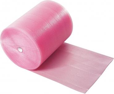 Das Bild zeigt eine Rolle pinkfarbene Folie, die ungerollt auf einer Seite liegt. Die Oberfläche ist leicht strukturiert und glänzt.