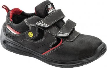 The shoe is black with red accents, has a sporty style, and two Velcro fasteners on the top. The sole is non-slip and provides good grip.