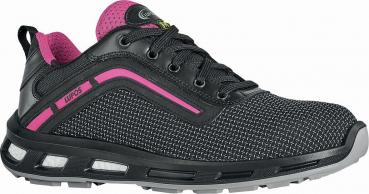 The shoe is a sport or casual shoe made of lightweight, black material. It has a textured surface, pink accents, and a grippy sole. The laces are black.