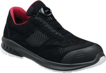 The shoe is a black athletic shoe with pink accents. It has a padded collar and two Velcro straps. The sole is lightweight and has a non-slip texture.