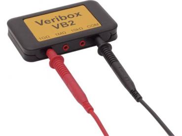 The image displays a compact, rectangular device with a yellow surface labeled "Veribox VB2". It features red and black inputs for electrical connections.