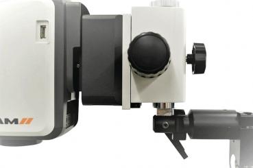 The image displays a technical device with a compact casing. It features a round rotary knob and a USB port. The device is mounted on a stable arm.