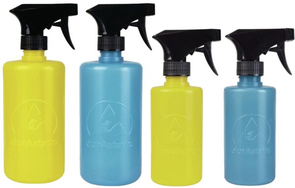 The image shows a blue spray bottle with a black spray head. The bottle has a round shape and is made of plastic. A logo in a light color is visible on the bottle.