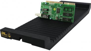 The image displays an elongated, black cooler with grooves and a green computer component resting on top. The card features black and silver components and shiny connections.