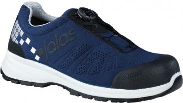 The shoe is black with white and red accents. It features a sporty design, a non-slip sole, and a reinforced toe cap. Instead of laces, there is a simple twist-lock system.