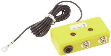 The image shows a yellow, rectangular casing with two sockets and a long, black cable. At one end of the cable, there is a metal eyelet for attachment.