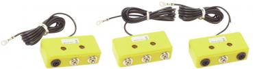 The image shows a yellow, rectangular casing with two sockets and a long, black cable. At one end of the cable, there is a metal eyelet for attachment.