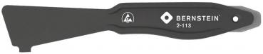 The image shows a long, narrow tool or lever pin in black color, which is flat and slightly rounded at both ends. In the middle, the word 