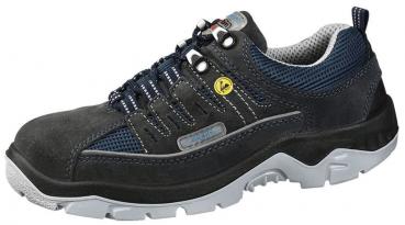 The shoe is a dark trekking or athletic shoe with a flexible, light-colored sole. It features a mesh upper for breathability and is equipped with laces and reinforced eyelets.