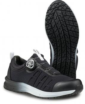 The image shows a black sports shoe with an elastic, breathable upper. The sole has a deep pattern for good grip. There is a special closure mechanism on the side.